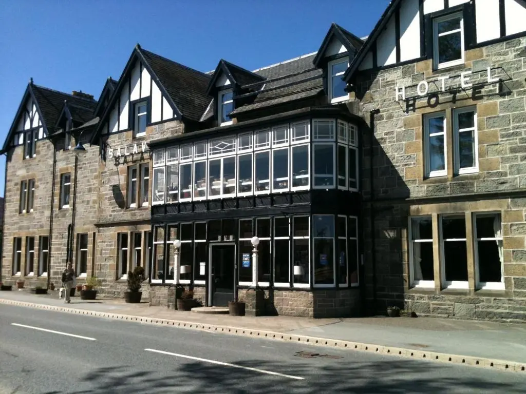 a large stone building on the side of a street at The Balavil Hotel Newtonmore - Restaurant, Bars & Swimming Pool in Newtonmore