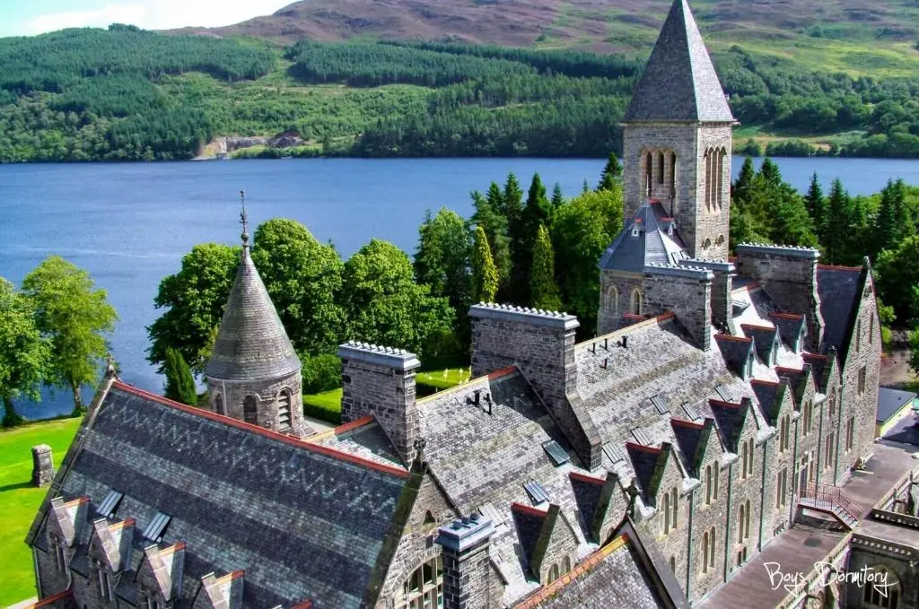 an aerial view of a castle with a lake in the background at Boys Dormitory in Fort Augustus