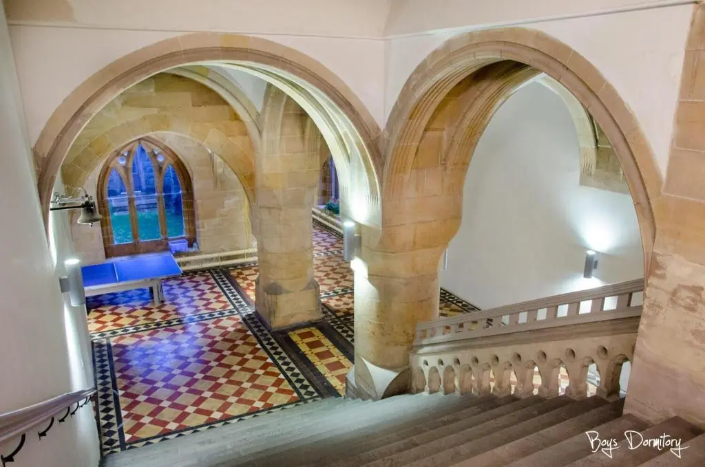 an image of a staircase in a castle with a stained glass window at Boys Dormitory in Fort Augustus