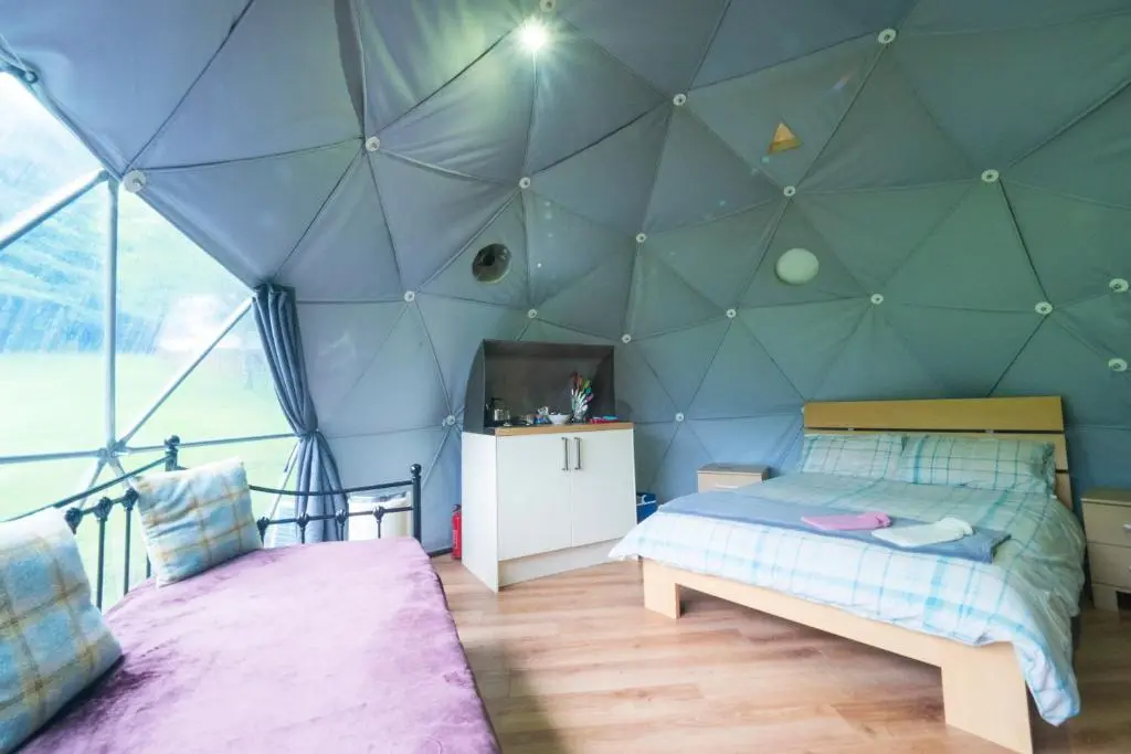a bedroom with a tent with a bed in it at Inver Coille Campsite in Fort Augustus