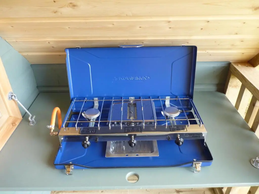 a blue stove sitting on top of a table at Inver Coille Campsite in Fort Augustus