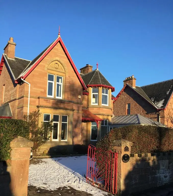 a house with a red gate in front of it at Ronas House in Inverness