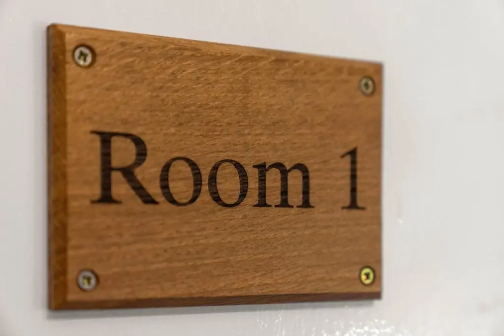 a wooden sign that reads room on a wall at mySTAYINN Strathblane House in Inverness