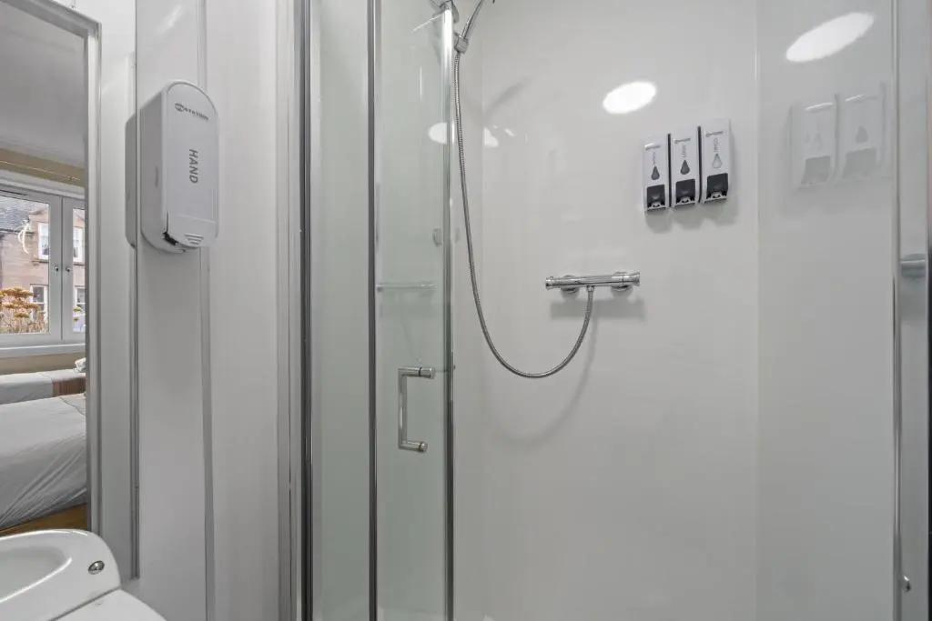 a bathroom with a shower and a toilet at mySTAYINN Strathblane House in Inverness