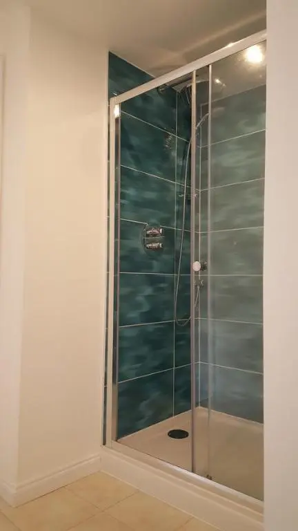 a shower with a glass door in a bathroom at Tighnabruaich Annex in Lossiemouth