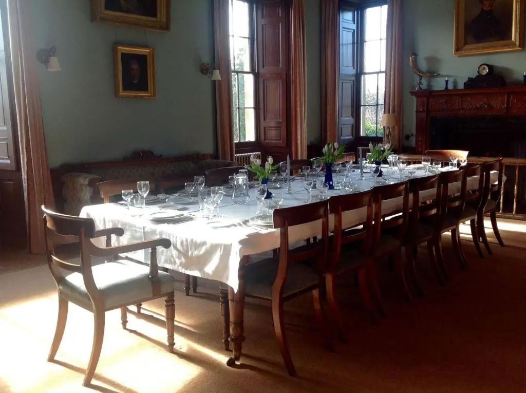 a dining room with a long table and chairs at Dalvey House in Forres