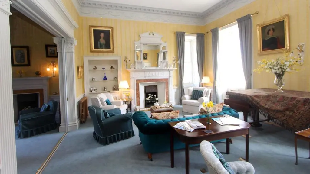 a living room filled with furniture and a fireplace at Dalvey House in Forres