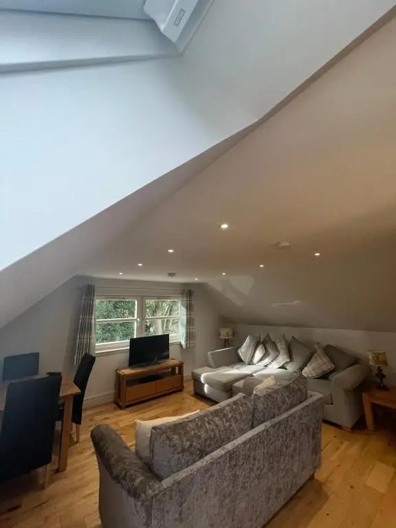 a living room with two couches and a television at Wee Corsee in Nairn