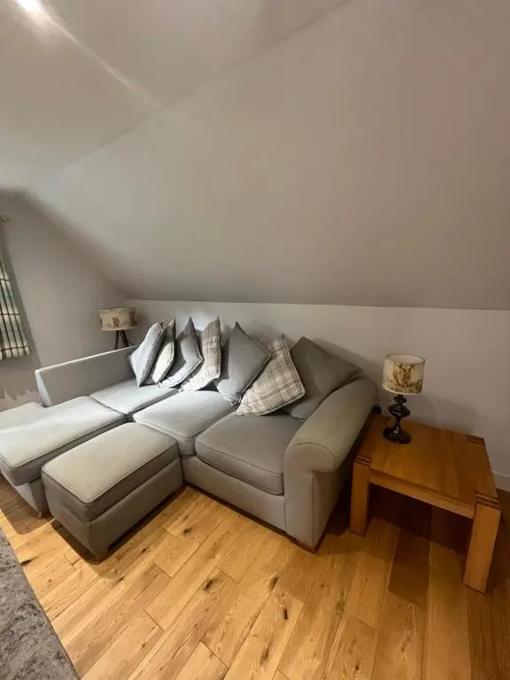 a living room with a couch and a table at Wee Corsee in Nairn