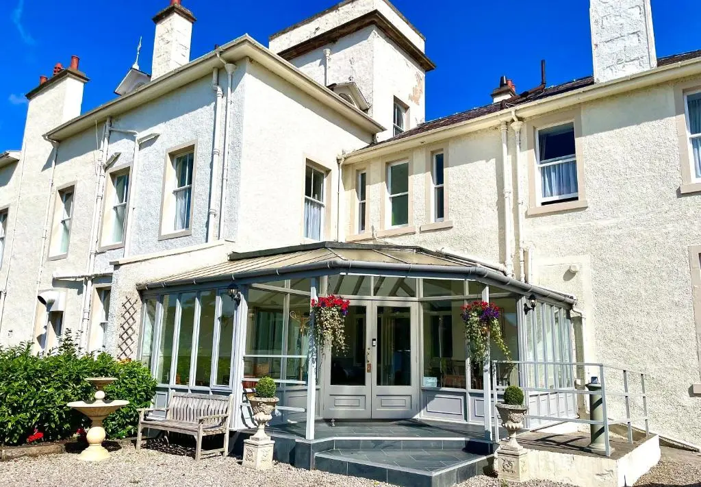 a house with a conservatory in front of it at Invernairne in Nairn