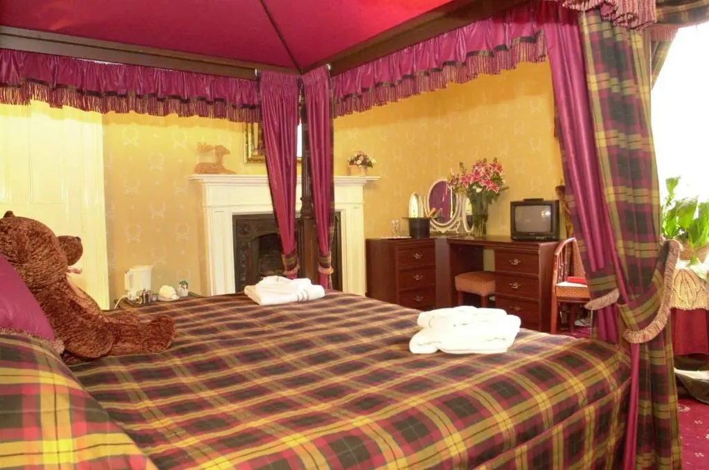 a bedroom with a bed with two towels on it at Atholl Arms in Blair Atholl