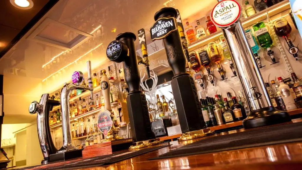 a bar with a lot of bottles of alcohol at Glenmoriston Arms Hotel in Invermoriston