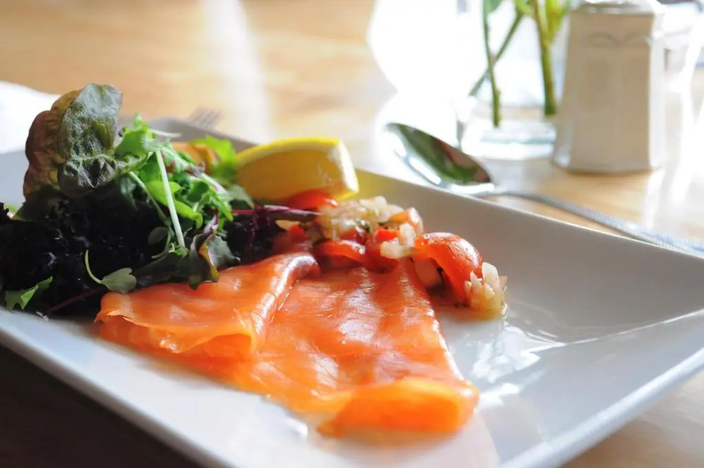 a plate of fish and a salad on a table at Inch Hotel in Fort Augustus