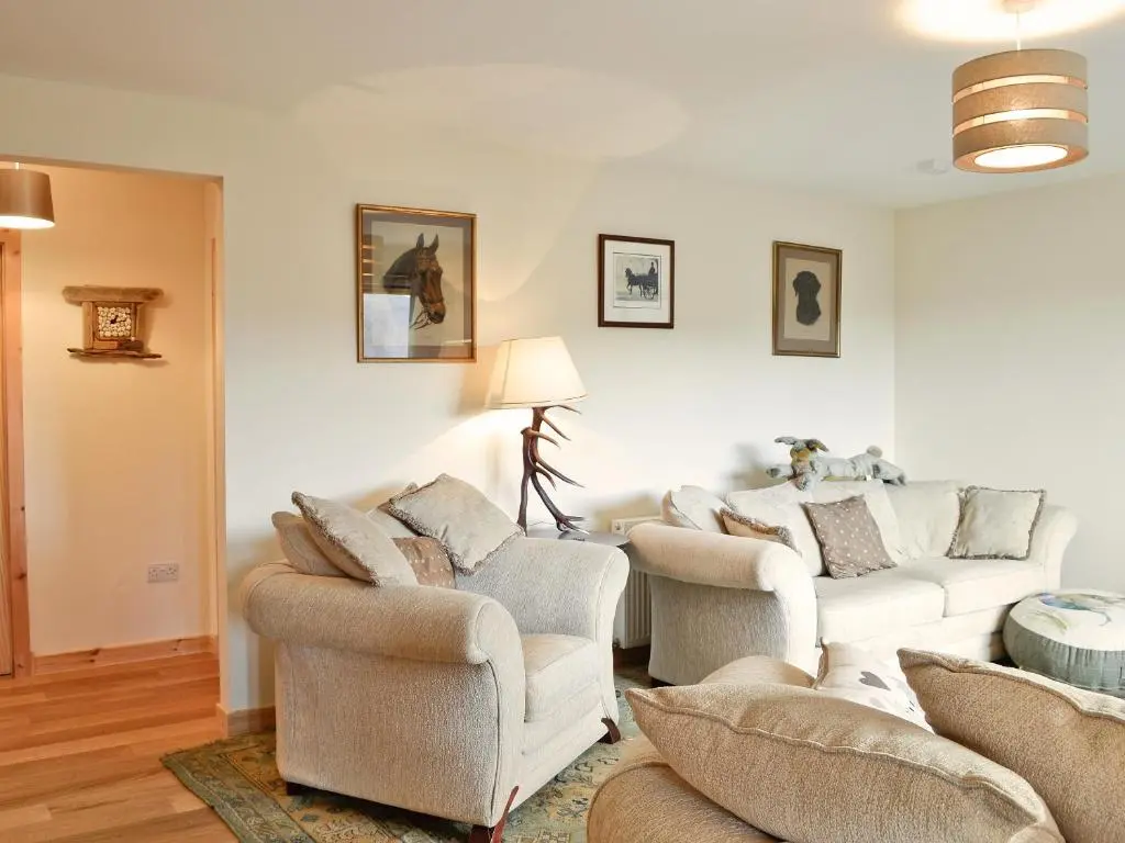 a living room with two couches and two chairs at Mountain View in Tomintoul