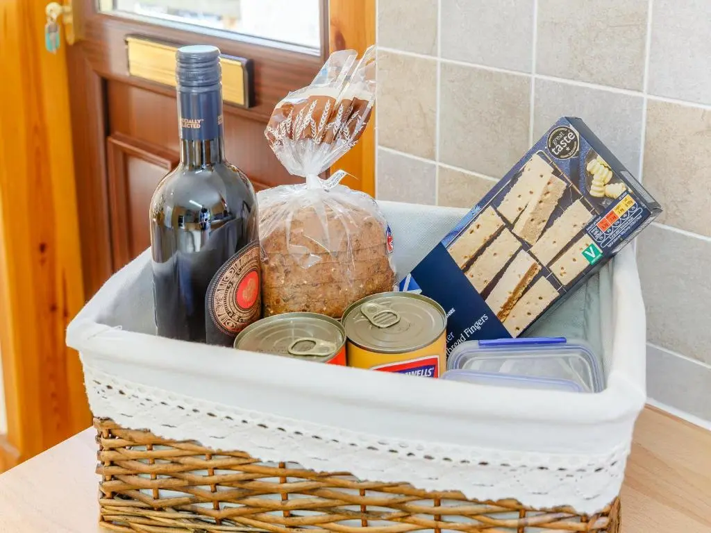 a basket filled with food and a bottle of wine at Glen View Of Enrick House in Bearnock