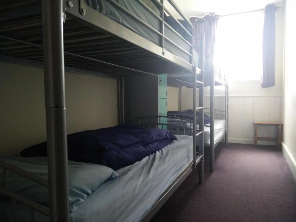 a bedroom with two bunk beds and a window at The Smugglers Hostel in Tomintoul