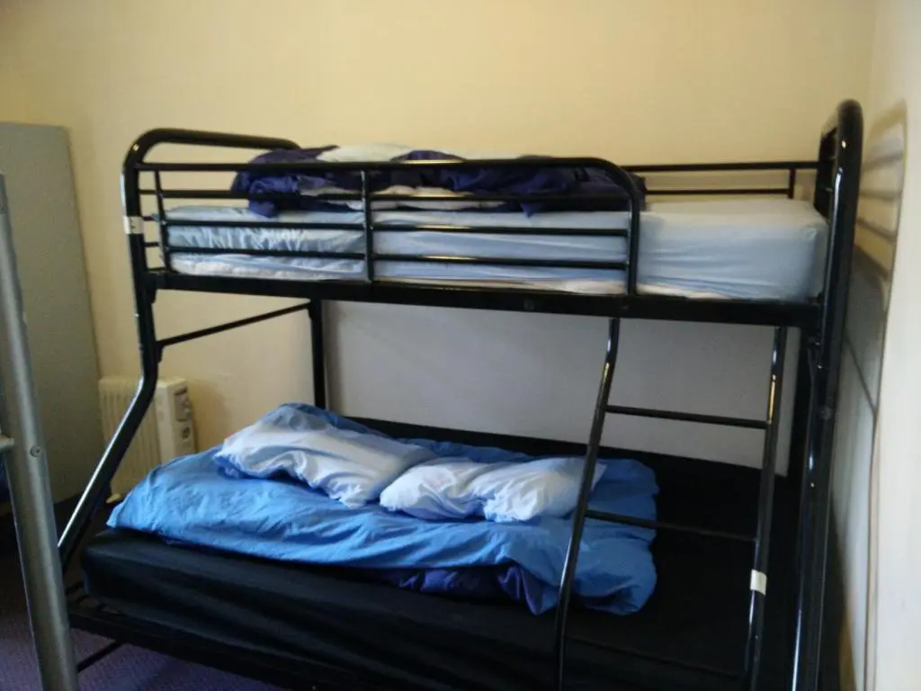 a couple of bunk beds in a room at The Smugglers Hostel in Tomintoul