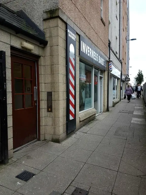 an empty sidewalk in front of a building at Lascala City Apartment in Inverness