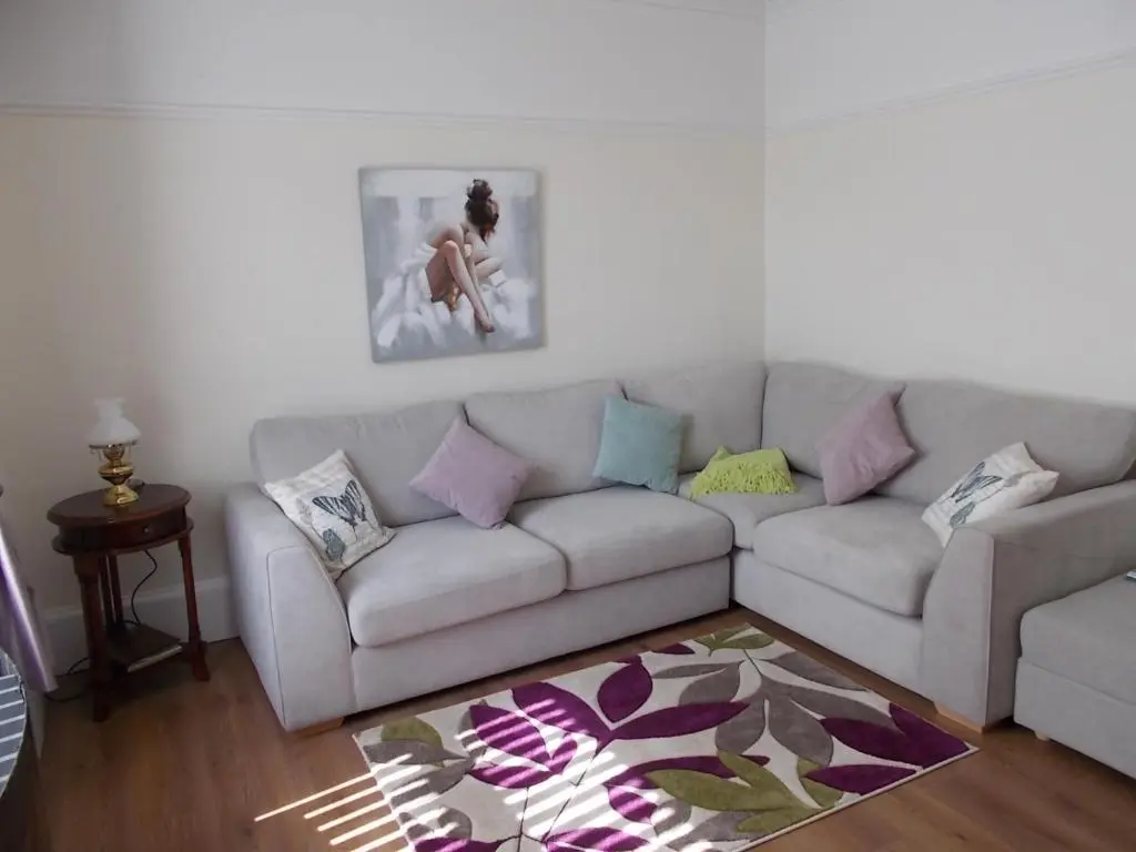 a living room with a couch with pillows on it at Inveravon Holiday Home in Dufftown