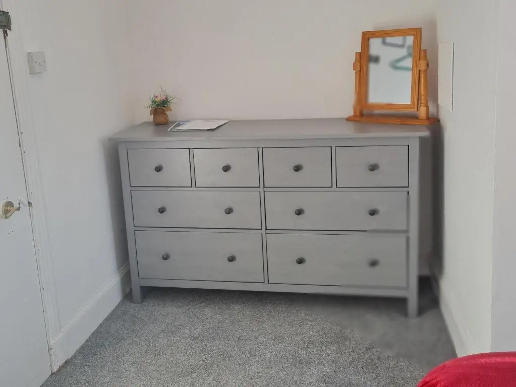 a dresser with a mirror on top of it at Victoria Hotel in Portknockie