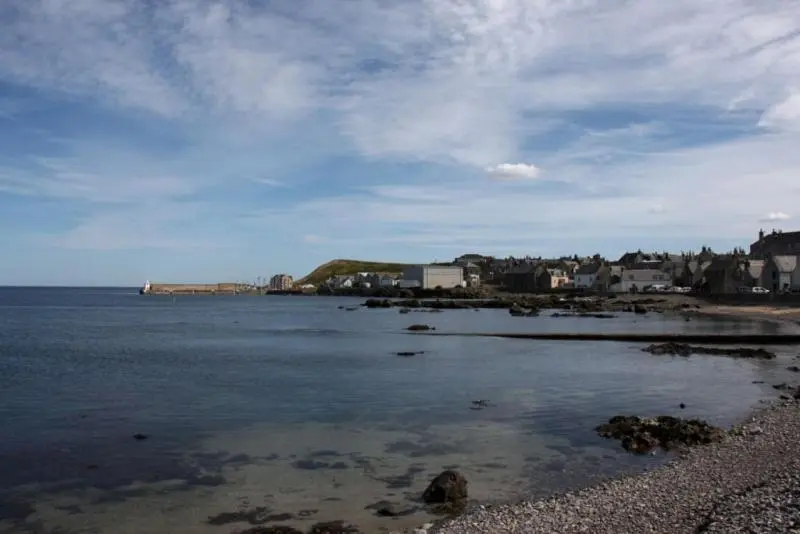 a view of a beach with houses and the ocean at Belvedere Holiday Home in Whitehills