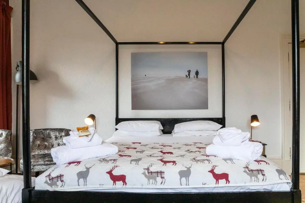 a bedroom with a bed with a picture of animals on it at Cawdor House B&B in Nairn