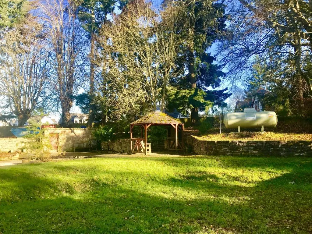 a garden with a gazebo in the middle of a yard at Drumdevan Country House in Inverness