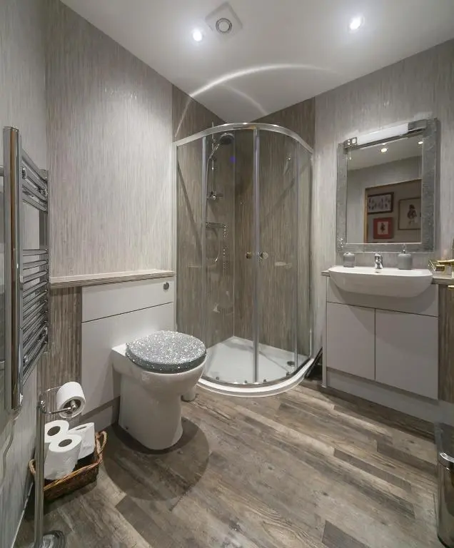 a bathroom with a shower and a toilet and a sink at Cosy Ness Escape, 16B Ardconnel Street in Inverness