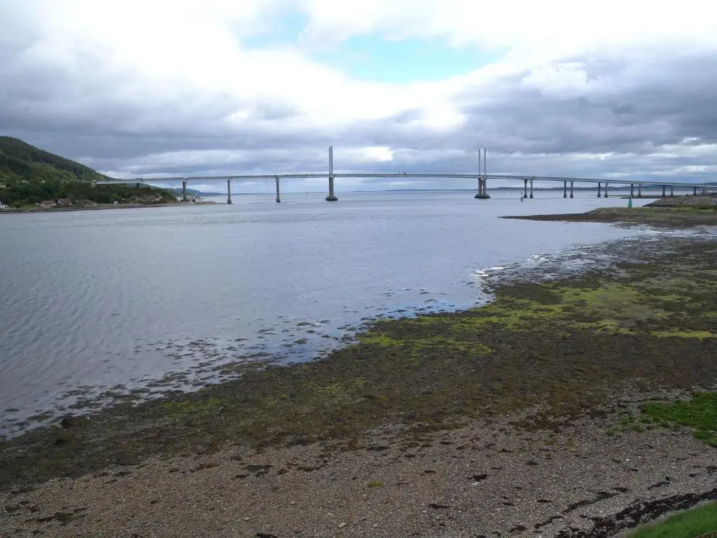 a bridge in the middle of a body of water at Tangle Tower in Inverness