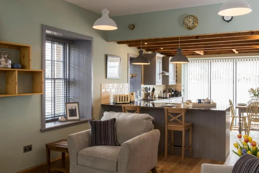 a kitchen and living room with a couch and chairs at Tangle Tower in Inverness