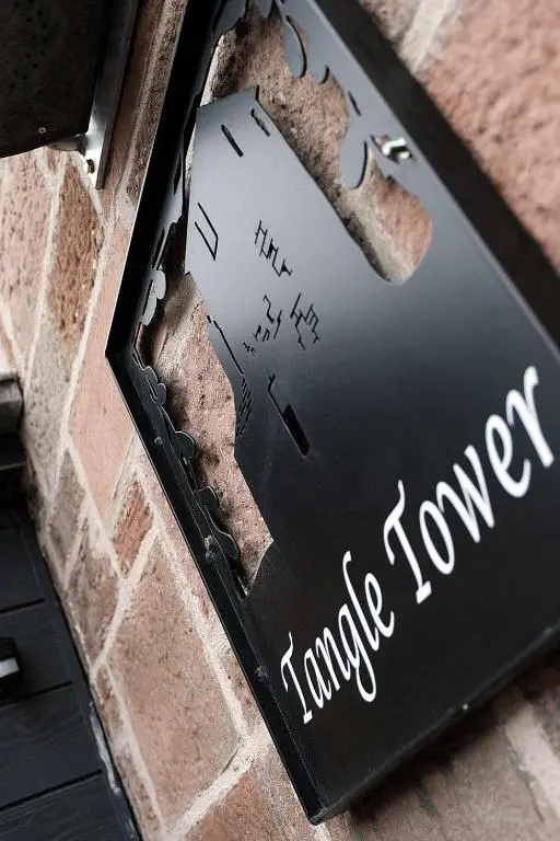 a sign on the side of a brick building at Tangle Tower in Inverness