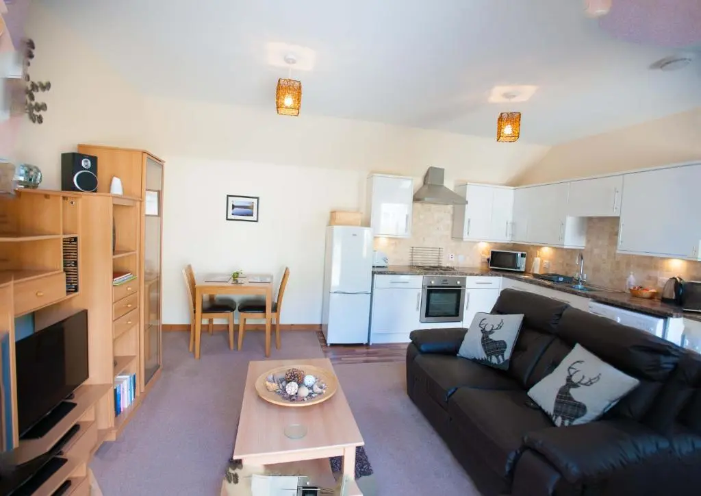 a living room with a couch and a table at Glenernan Self Catering Cottages in Ballater