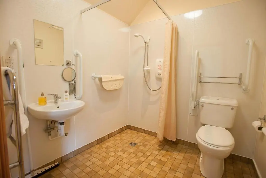a bathroom with a toilet and a sink at Glenernan Self Catering Cottages in Ballater