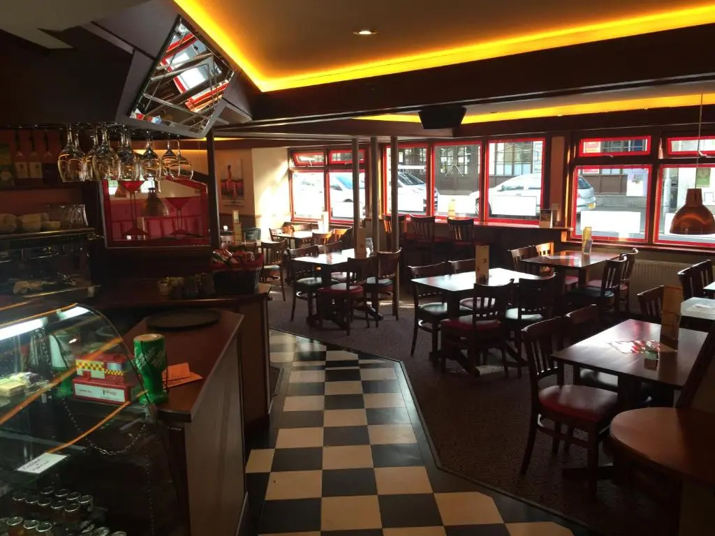a restaurant with tables and chairs in a restaurant at Buchan Hotel in Ellon