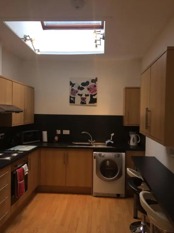 a kitchen with a sink and a dishwasher at Eastgate Apartment in Inverness