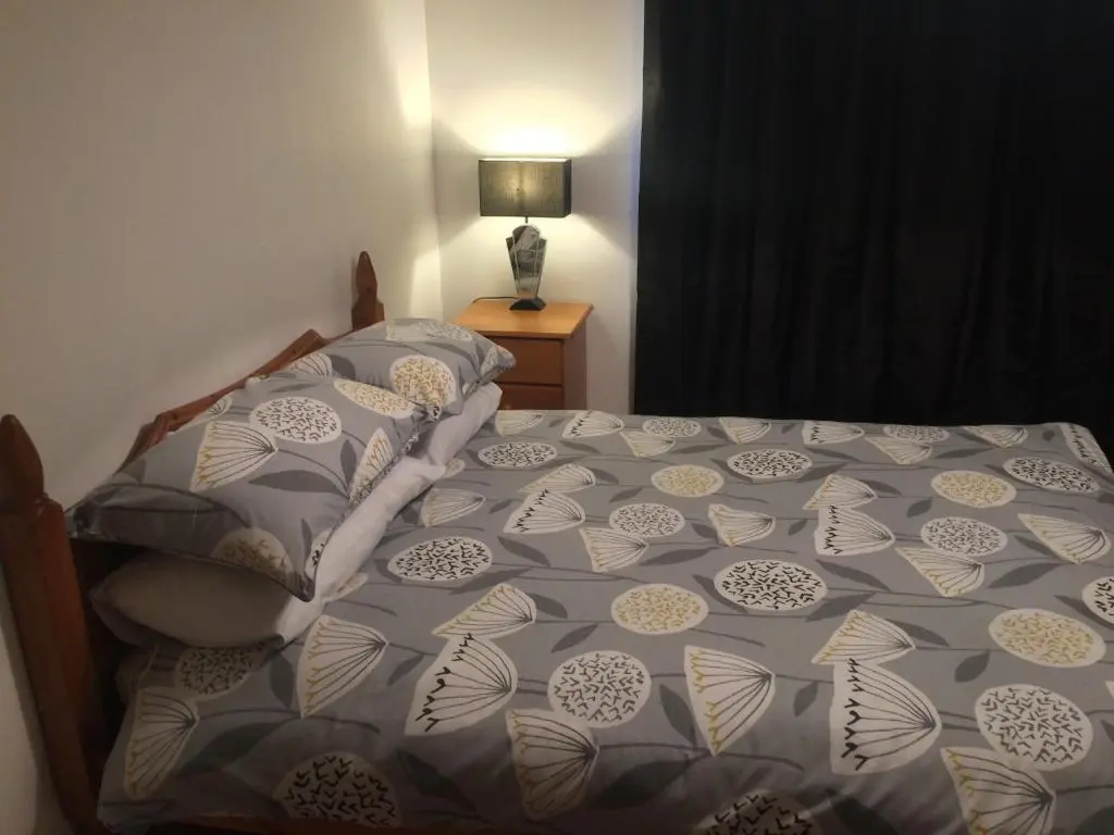 a bedroom with a bed with a comforter on it at Eastgate Apartment in Inverness