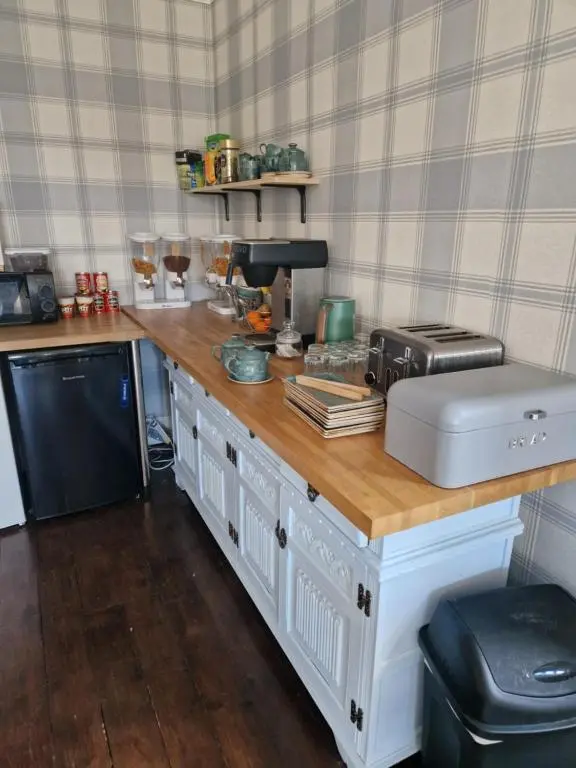 a kitchen with a wooden counter top with a appliance at Strathardle Lodge in Kirkmichael
