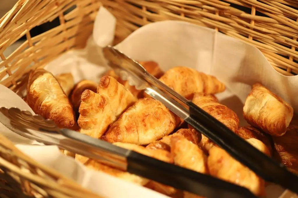 a basket of food with tongs and pastries in it at Ben Wyvis Hotel in Strathpeffer