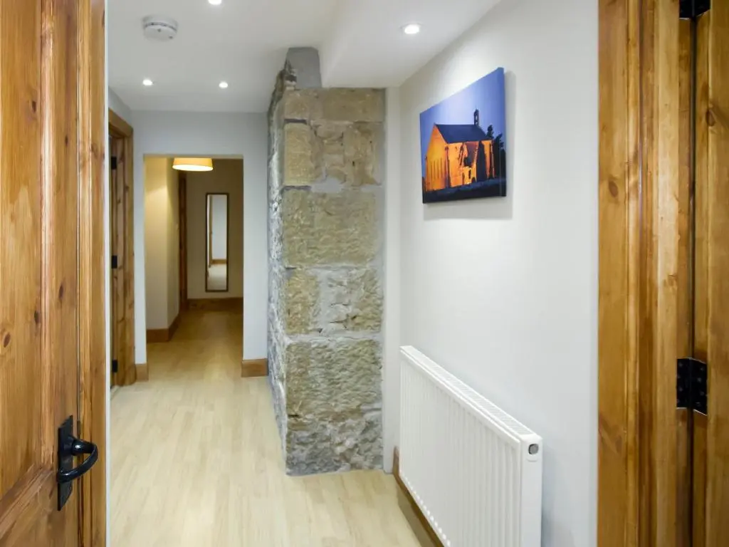 a hallway of a house with a stone wall at The Paddock in Portmahomack