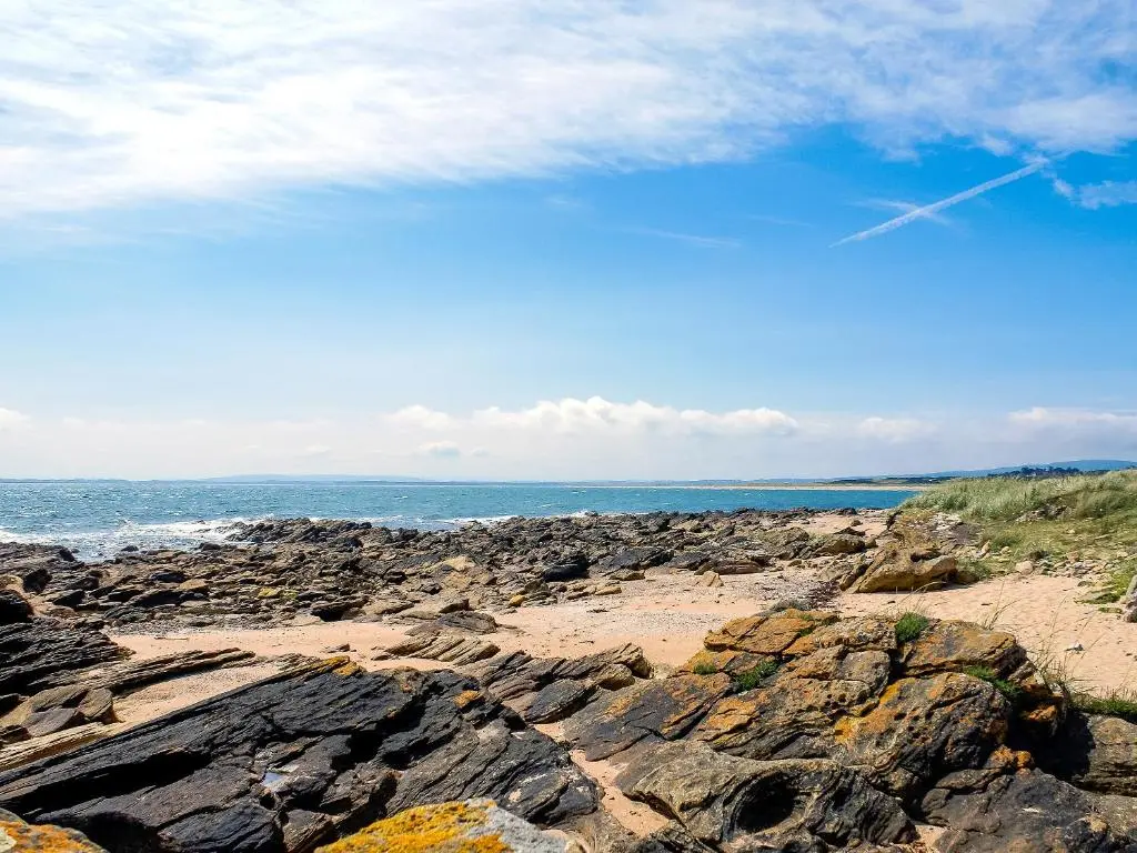 a rocky beach with the ocean in the background at The Wee Hoose in Achnahanat