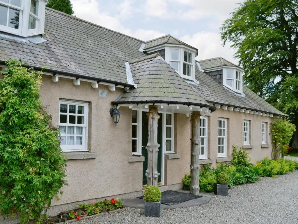a house with white windows and a roof at Little Blackhall Lodge in Banchory