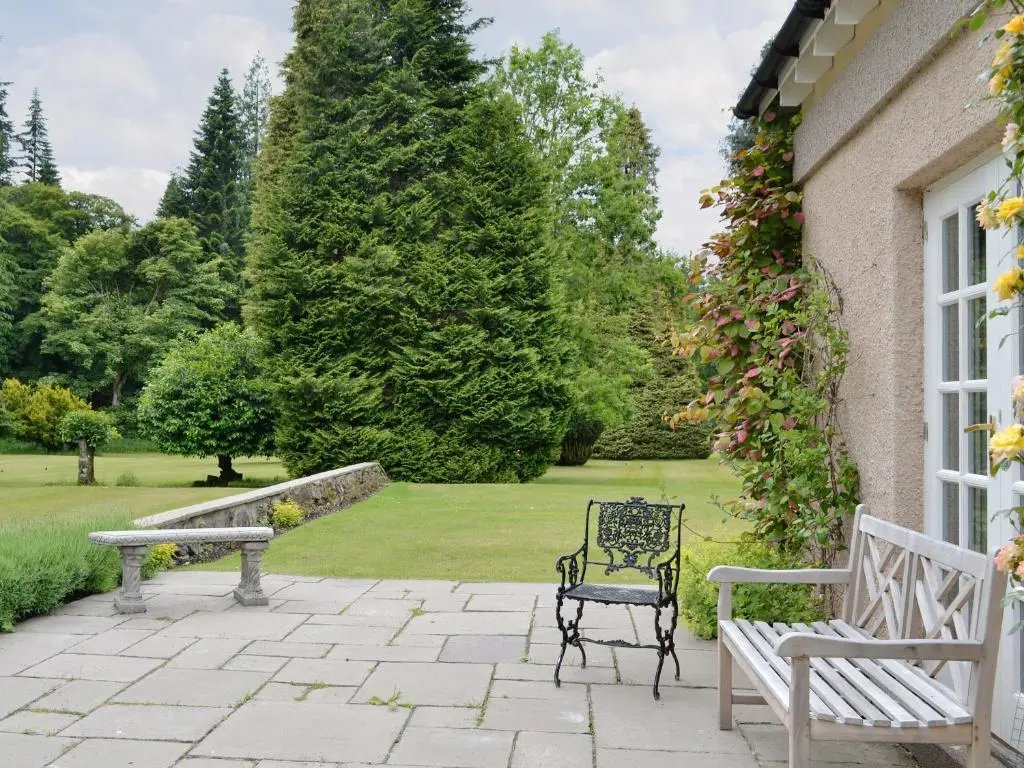 a couple of benches sitting on a patio at Little Blackhall Lodge in Banchory