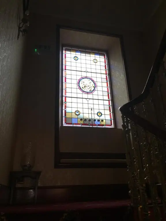 a stained glass window on the side of a staircase at Craignay Guest House in Inverness