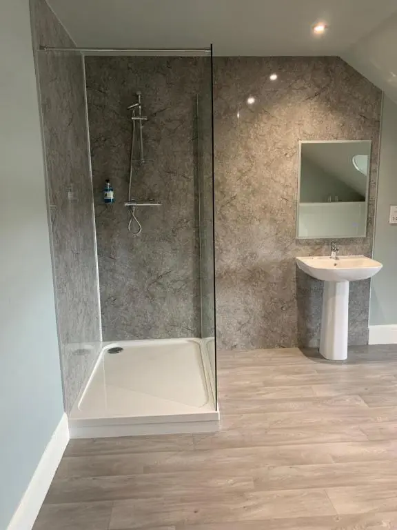 a bathroom with a shower and a sink at The Royal Hotel Elgin in Elgin