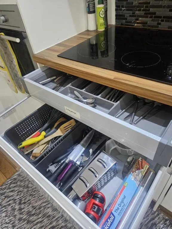 an open refrigerator drawer filled with lots of tools at LANGLEY APARTMENT free parking outside between 6 pm and 8 am Secure parking 2 min walk Ideal for TRADES AND TOURISTS WANTING GREAT LOCATION in Inverness