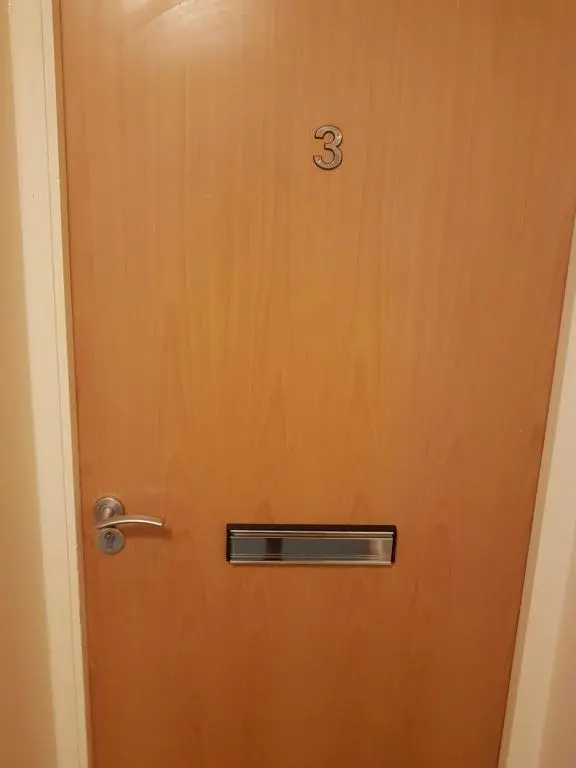 a wooden door with the number three on it at LANGLEY APARTMENT free parking outside between 6 pm and 8 am Secure parking 2 min walk Ideal for TRADES AND TOURISTS WANTING GREAT LOCATION in Inverness