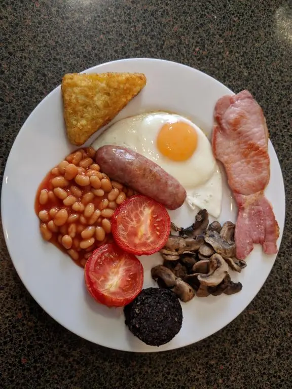 a plate of breakfast food with eggs bacon beans and toast at St Ann\u2019s Guest House in Inverness