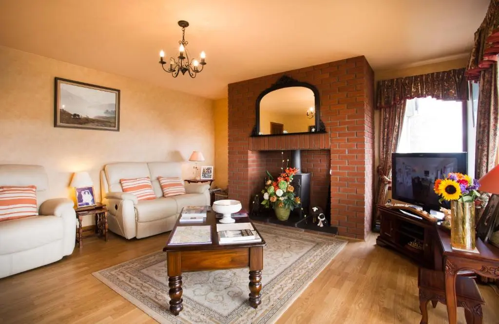 a living room with a couch and a fireplace at Leanach Farm in Inverness