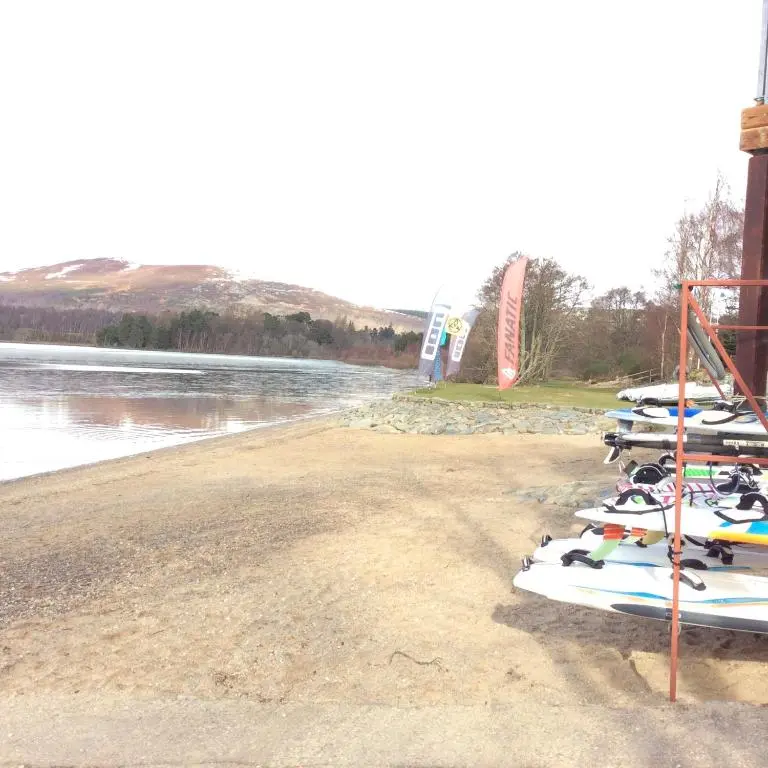a row of surfboards are lined up on a beach at Holiday House Kinveachy in Aviemore