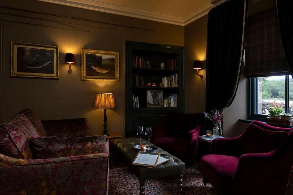 a living room with a couch and a table at Kildrummy Inn in Kildrummy